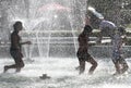 Kids play in a water of a fountain on a sunny summer day during summer break in Sofia, Bulgaria Ã¢â¬â june 15, 2012. Sunny weather c Royalty Free Stock Photo